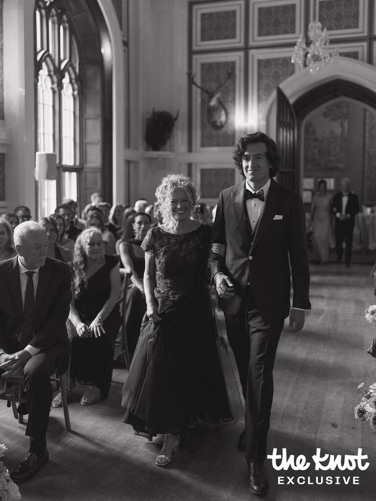 Logan Rae Hill walking down the aisle with his mom during his wedding ceremony