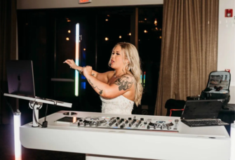 Bride at the DJ booth at wedding reception with music by Pure Vision Entertainment in Fairview, Oregon