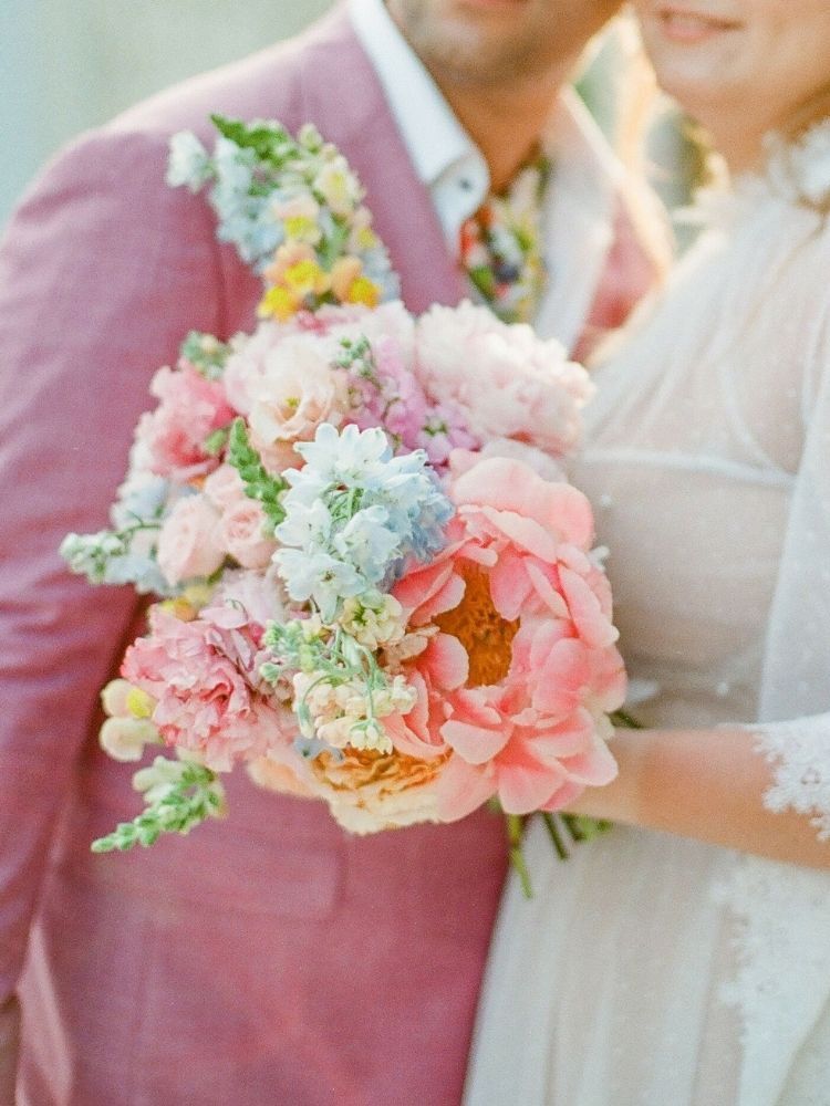bride holding pastel peony bouquet