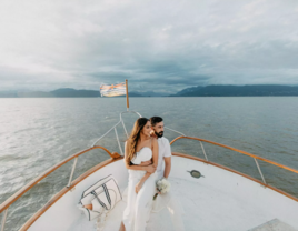 Bride and Groom at Pre-Wedding Event on Bow of Boat