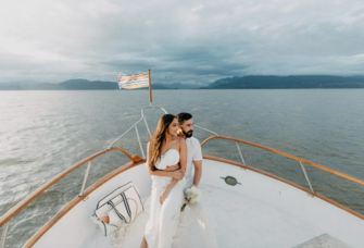 Bride and Groom at Pre-Wedding Event on Bow of Boat