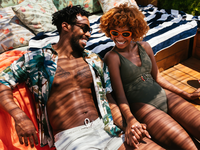 Couple smiling with each other on terrace, what is a honeymoon