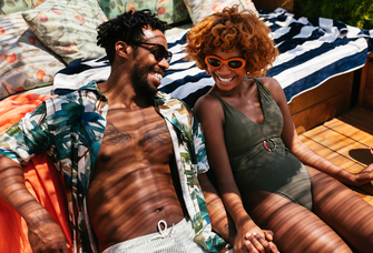 Couple smiling with each other on terrace, what is a honeymoon