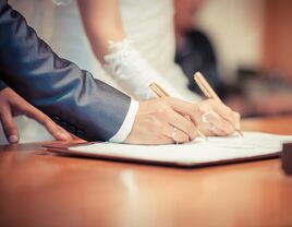 Bride and groom signing their marriage certificate