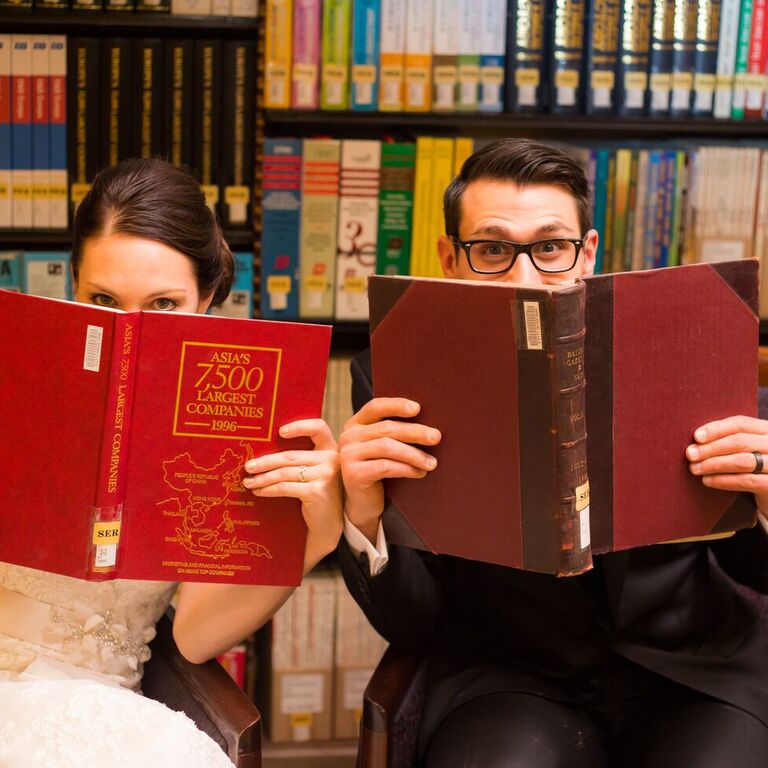 couple posing with books