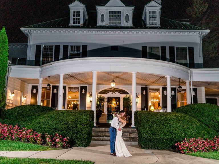 Couple kissing in front of the charming venue