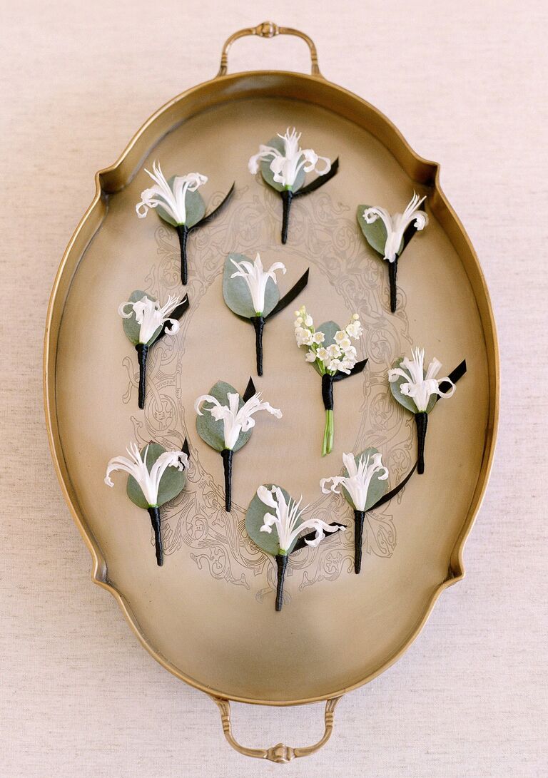 Antique tray with boutonnieres sitting on it