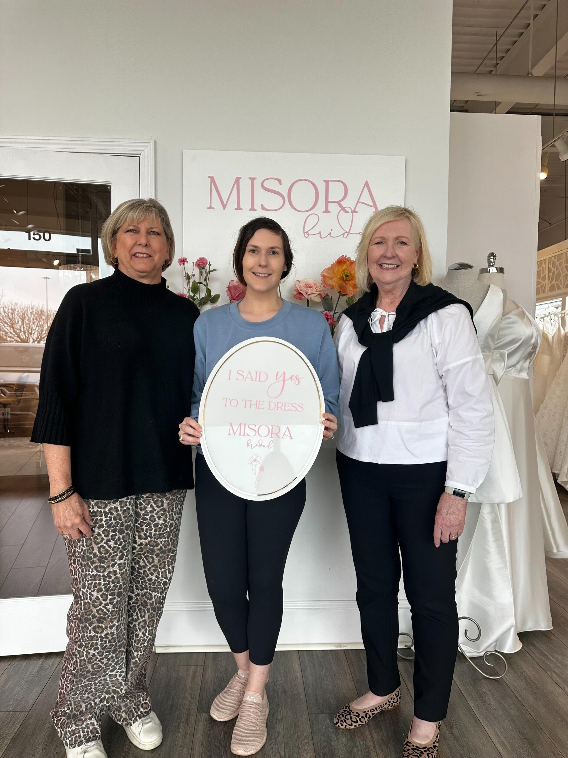 Kelly found her wedding dress with a bit of help from Melia (Kelly's mom) and Jennifer (Travis' mom)