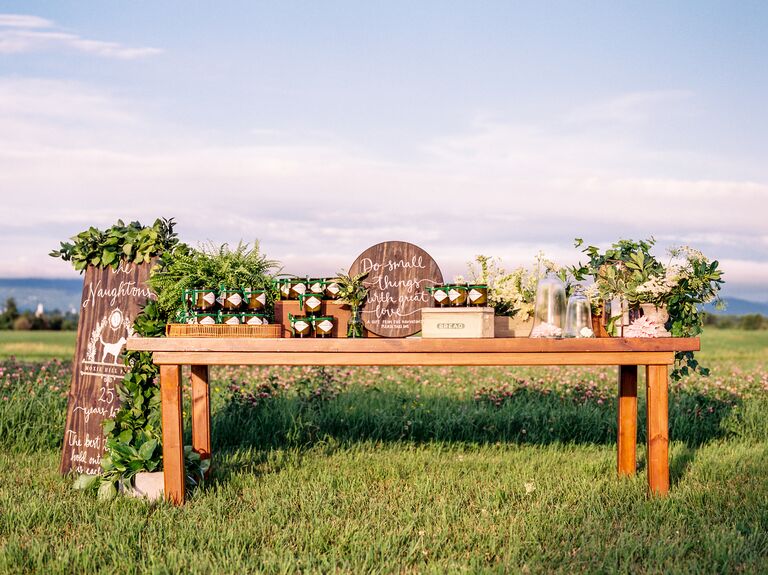 outdoor wedding favor display with wooden table at countryside meadow