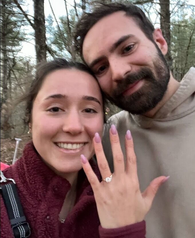 Kyle Proposed to Danielle during a dog walk in the woods behind her parents house.  He surprised her with a family party immediately after 