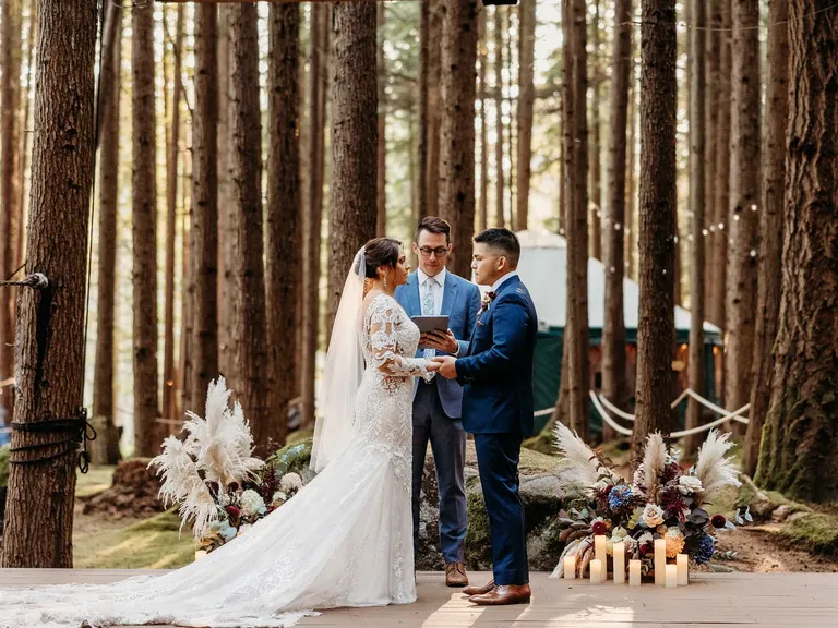 Bride and groom getting married in forrest 