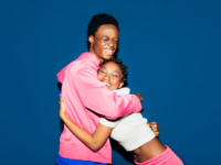 Couple hugging in front of blue wall