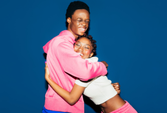 Couple hugging in front of blue wall