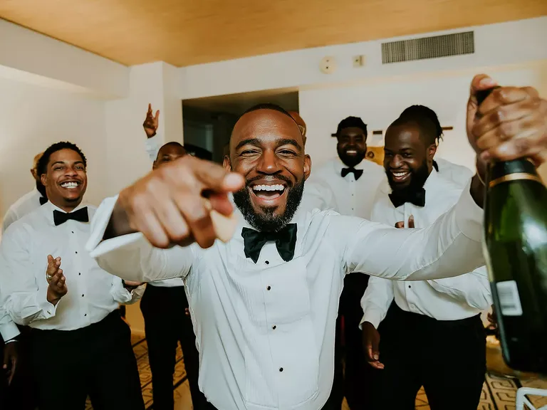 Groomsmen Getting Ready Around Groom With Champagne, Tuxedo Suits