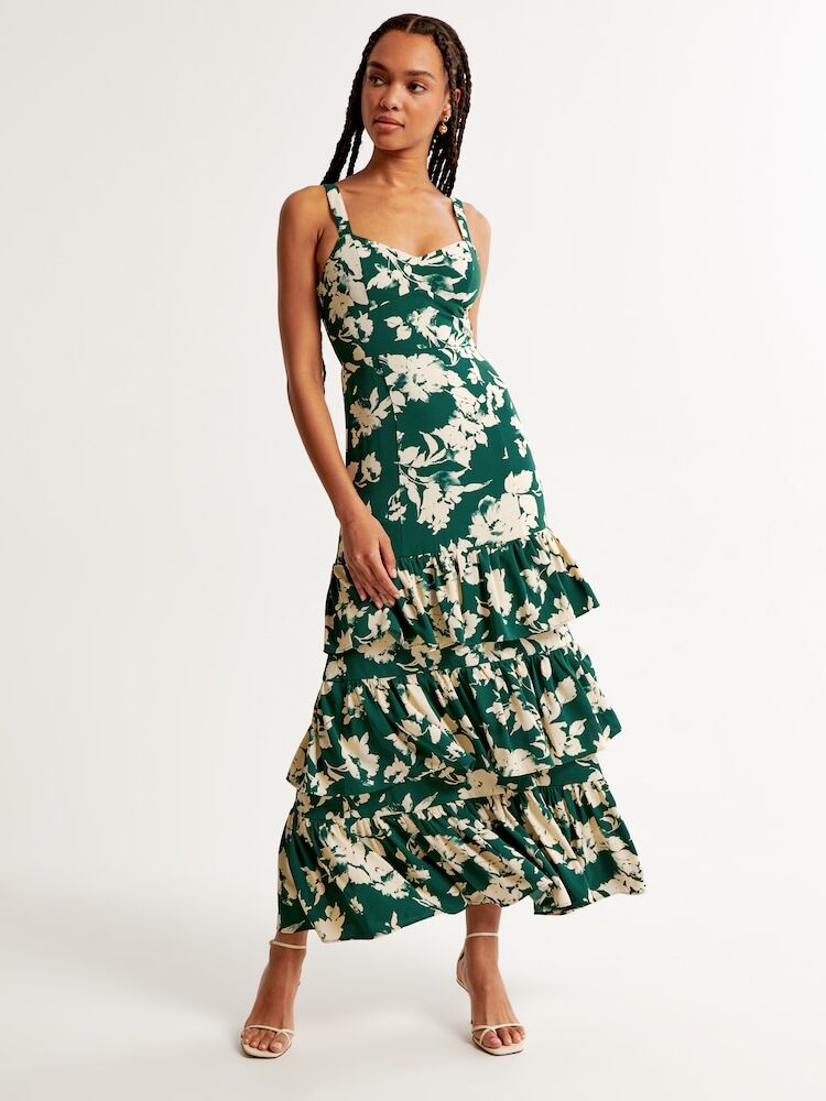 Model wearing a ruffle tiered maxi dress in green and cream. 
