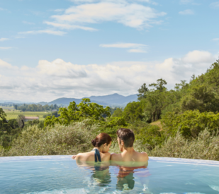 Couple in resort pool over looking Napa Valley, California, mini-moon ideas