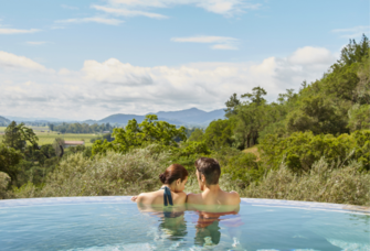 Couple in resort pool over looking Napa Valley, California, mini-moon ideas