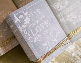 'Our Love Story' in vintage white type on faded gray book box cover