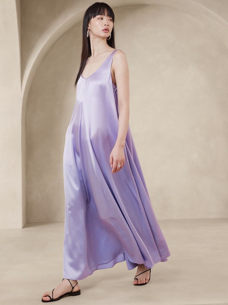 Pastel purple silk wedding guest dress with flowy silhouette on model