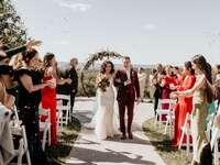 Couple walking down the aisle together after their outdoor ceremony