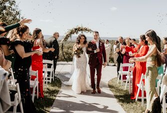 Couple walking down the aisle together after their outdoor ceremony