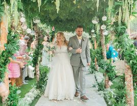 Couple walking down the aisle at fairytale-themed wedding