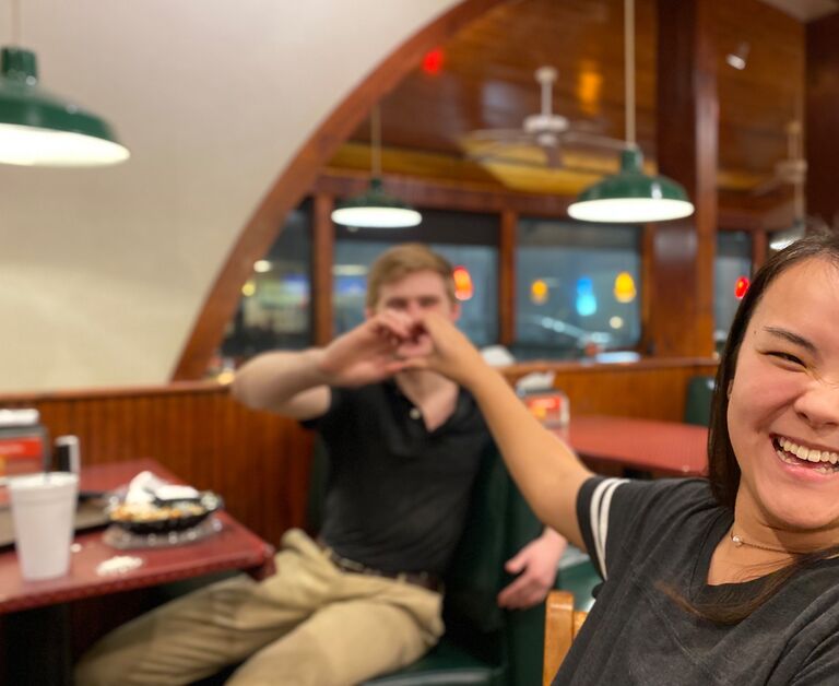  It all started at Tenda Chick, a local chicken restaurant. A coworker took this photo of Chris and Sara while they were on break. Foreshadowing at its finest!           
        *This is their attempt at making a heart*
