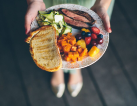 Wedding guest holding dinner plate at reception