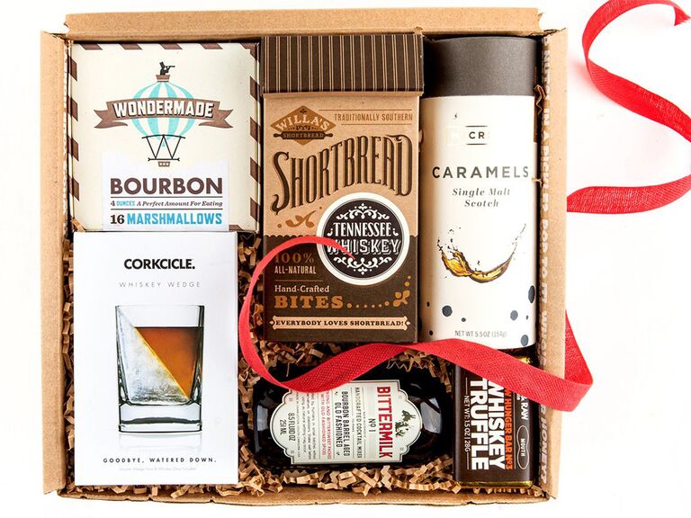 Gift box with snacks that pair well with whiskey like caramels, shortbread, marshmallows, etc. and whiskey glass