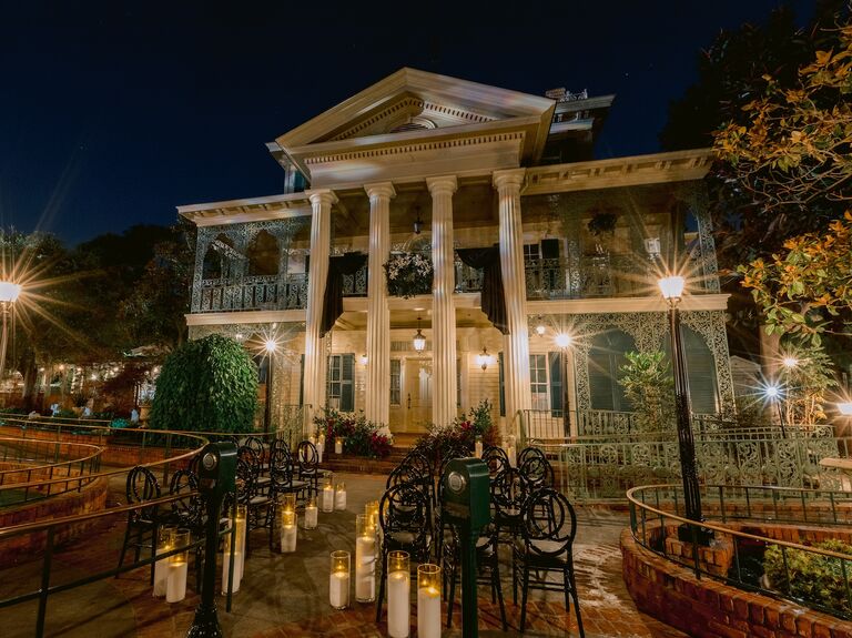 The Haunted Mansion Disneyland wedding venue with bride and groom in courtyard
