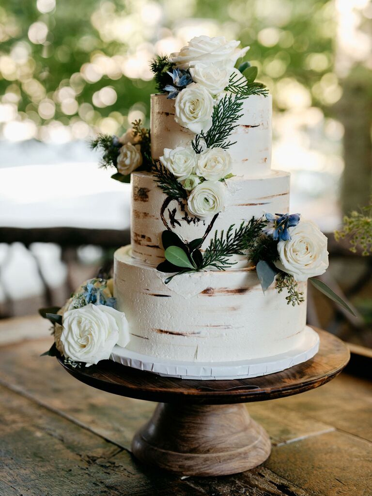 Three-tier rustic wedding cake with birch tree design and fresh flowers