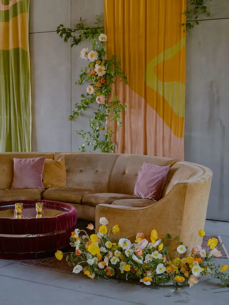 Retro 1970s Lounge Setup With Velvet Details and Colorful DIY Art Backdrops