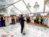 Couple dancing surrounded by guests at country club wedding