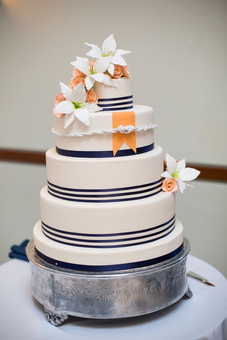 Four Tier Navy Striped Wedding Cake With Orange And White Flowers
