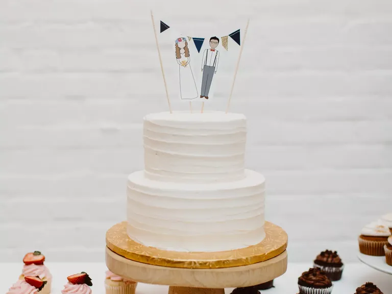 White Wedding Cake With a Personalized Topper