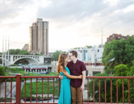 Couple hugging on bridge in Minnesota