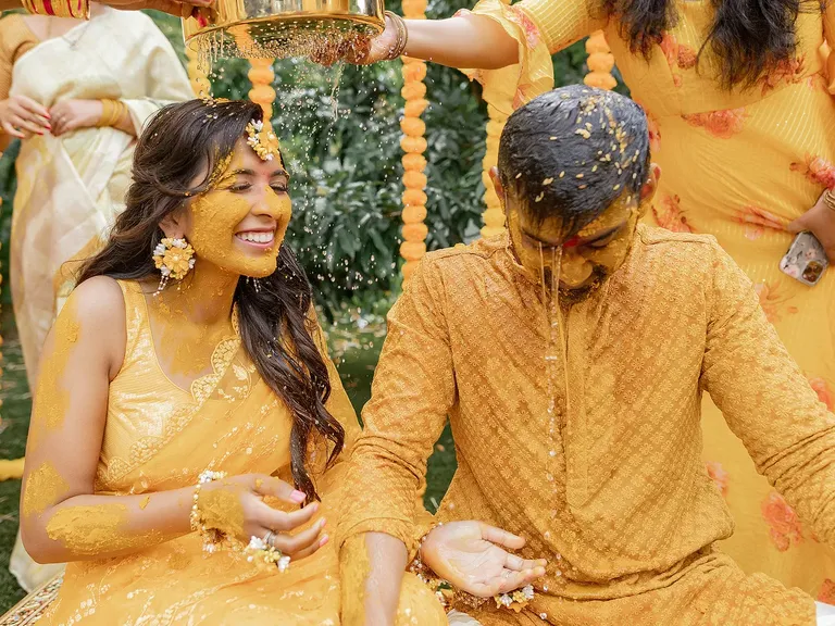 Bride and Groom Doused in Yellow Tumeric at Haldi Ceremony, Traditional Indian Wedding
