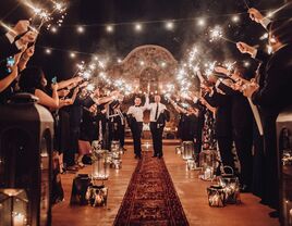 Couple celebrating while walking down the aisle with loved ones