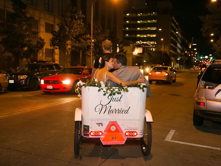 Couple kissing in a just married bike