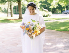 Bridal Portrait of Bride in Short-Sleeved Gown With Long Veil and Colorful Spring Bouquet