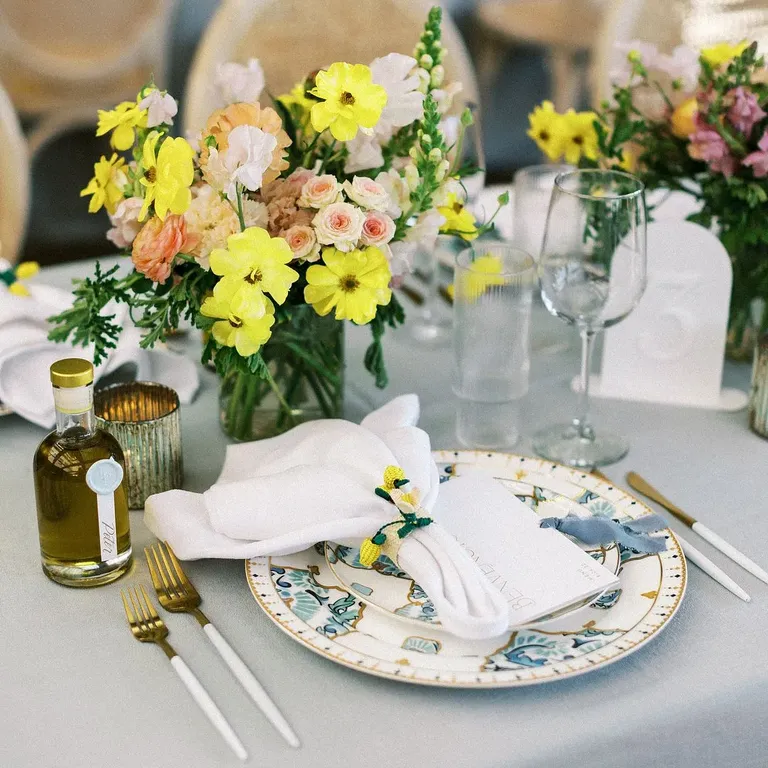 Blue-and-White Charger Plates, Blue Linen and Low Bright Centerpiece With Lemon Napkin Ring Rehearsal Dinner Decor Inspiration