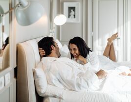 couple in robes on bed