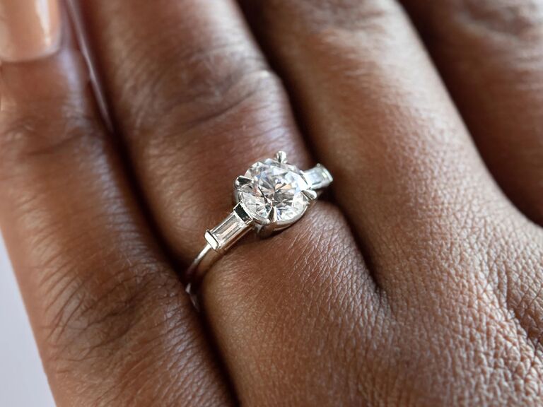 classic engagement ring with alternative diamond and two side stones