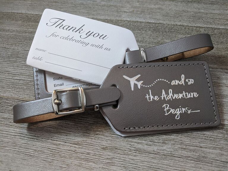 Leather luggage tags with airplane graphic and 'and so the adventure begins...' in silver type