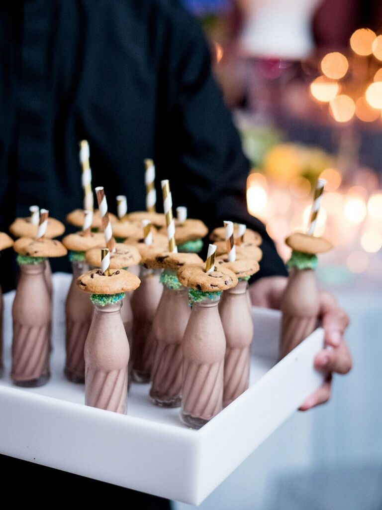 Tray of milkshakes topped with chocolate chip cookies. 