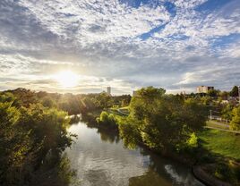 The sun rises over a gorgeous river landscape