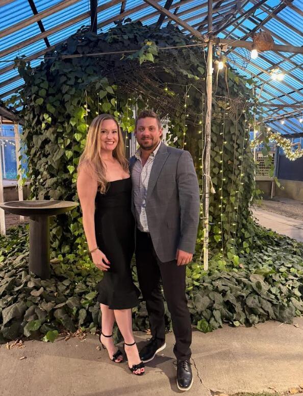 At a family wedding reception in Detroit, MI.   Kelly didn't know it yet, but Luke had bought the engagement ring one day prior to this photo being taken!