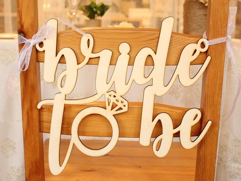'bride to be' in wooden script with o in 'to' in shape of ring 