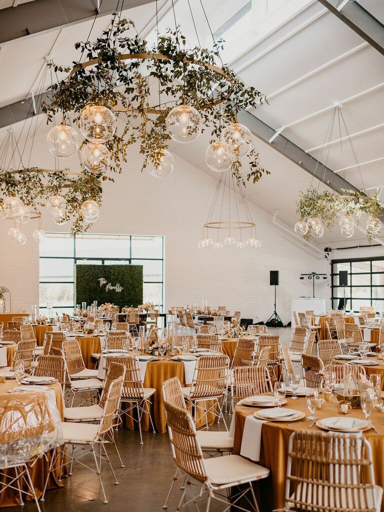 Rustic barn wedding venue with modern gold angular lighting installations