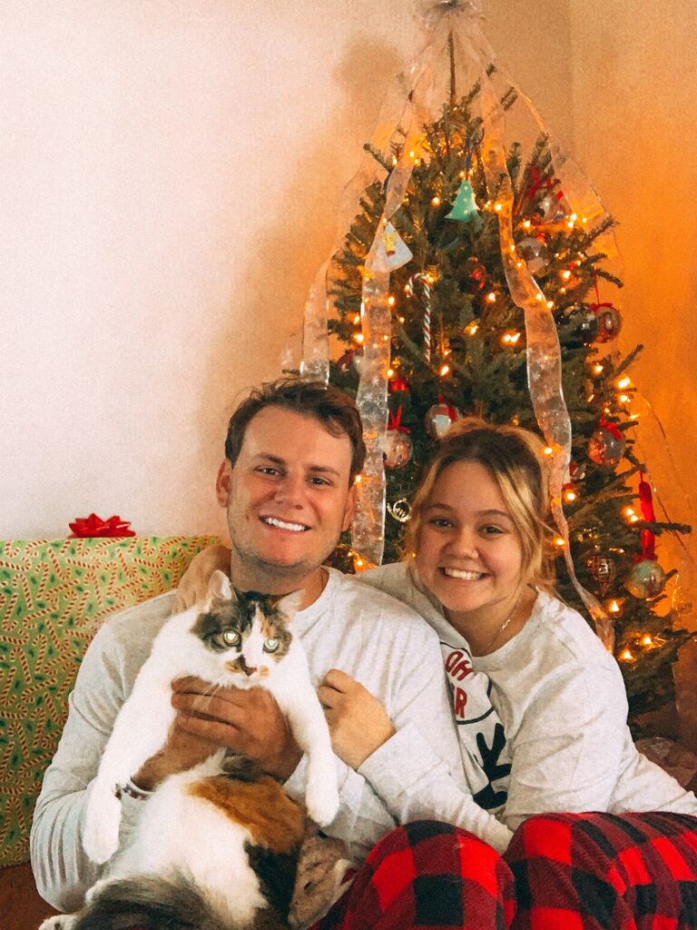 Our first Christmas together with our cat Bella! This was Zach's grandmother's cat and we fell in love with her.  We were surprised we got her to hold so still in this photo. She is a feisty cat but loves cuddles (on her own time)!